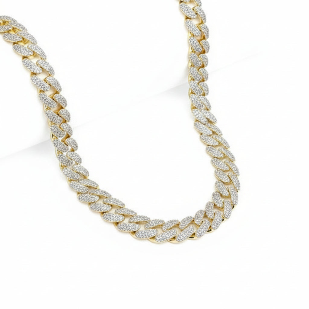 Gold chain necklace with diamond accents on a white background