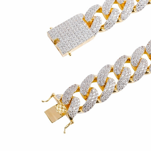 Gold chain bracelet with diamond-like stones on a white background