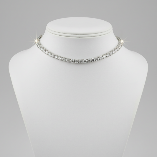 Silver necklace on a mannequin bust against a gray background