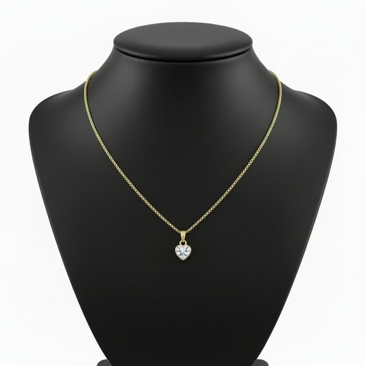 Gold heart necklace on a black jewelry stand with a white background