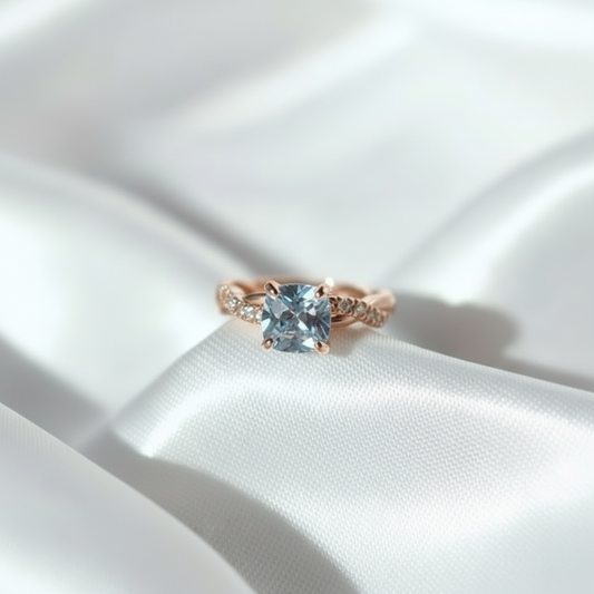 Gold ring with a large diamond on a white fabric background