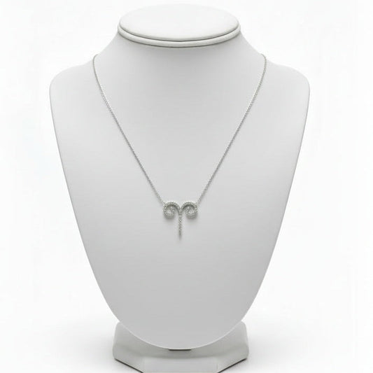 Necklace on a white mannequin bust with a white background